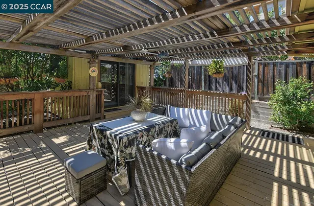 a work room with furniture a rug and a large window