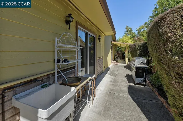 a kitchen with white cabinets stainless steel appliances and wooden floor