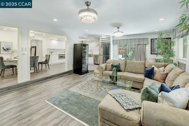 a room with white cabinets and wooden floor