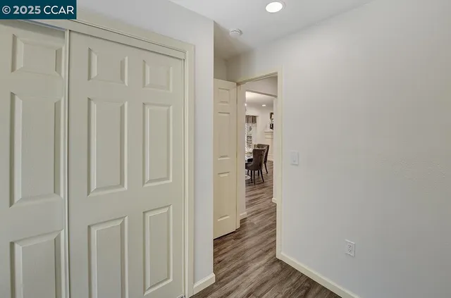 a bedroom with a bed tv and a window