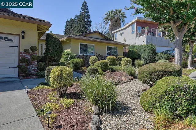 a front view of house with yard and outdoor seating