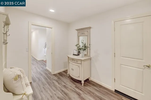 a bedroom with a large bed and a night stand