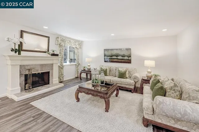 a living room with furniture and a fireplace