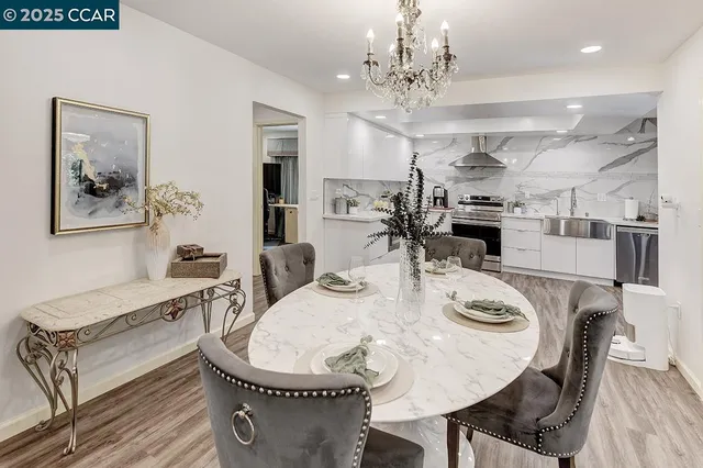 a very nice looking dining room with kitchen island a table and chairs