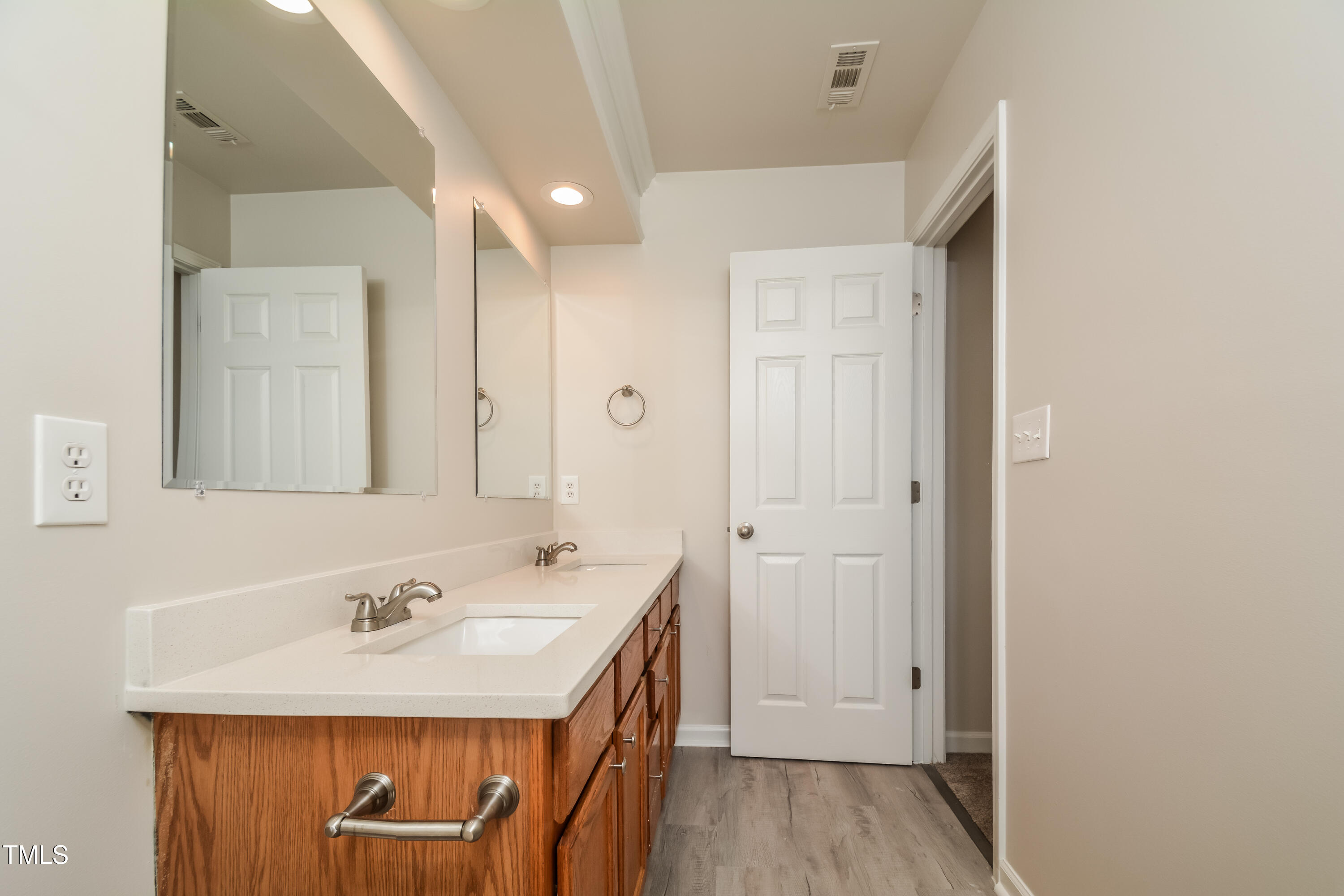745 Southgate Drive Raleigh, NC 27610 - Photo 7 of 17 a bathroom with a sink a mirror and a shower