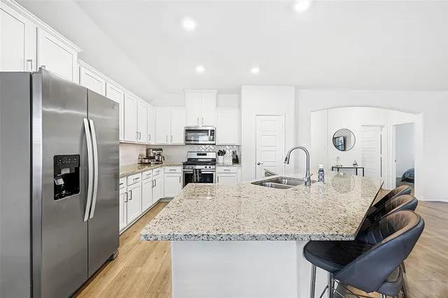 a kitchen with granite countertop a stove and a sink