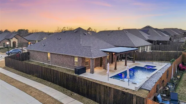 a view of house with roof deck and chair