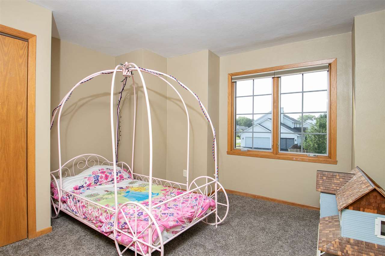 6820 Stone Cottage Road Rockford, IL 61114 - Photo 15 of 24 a bed sitting in a bedroom next to a window