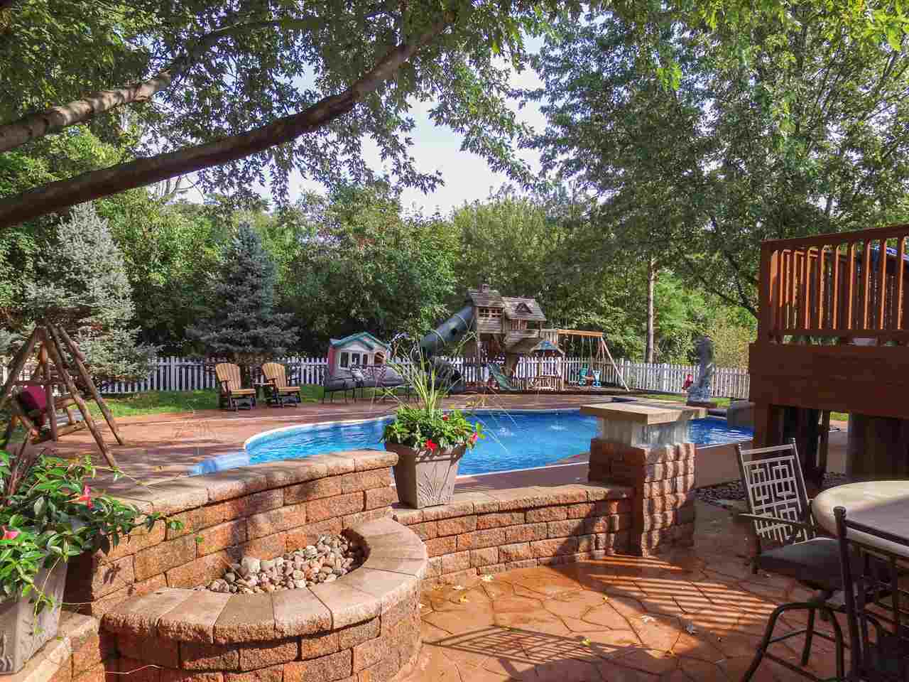 6820 Stone Cottage Road Rockford, IL 61114 - Photo 23 of 24 a view of a swimming pool with an outdoor seating