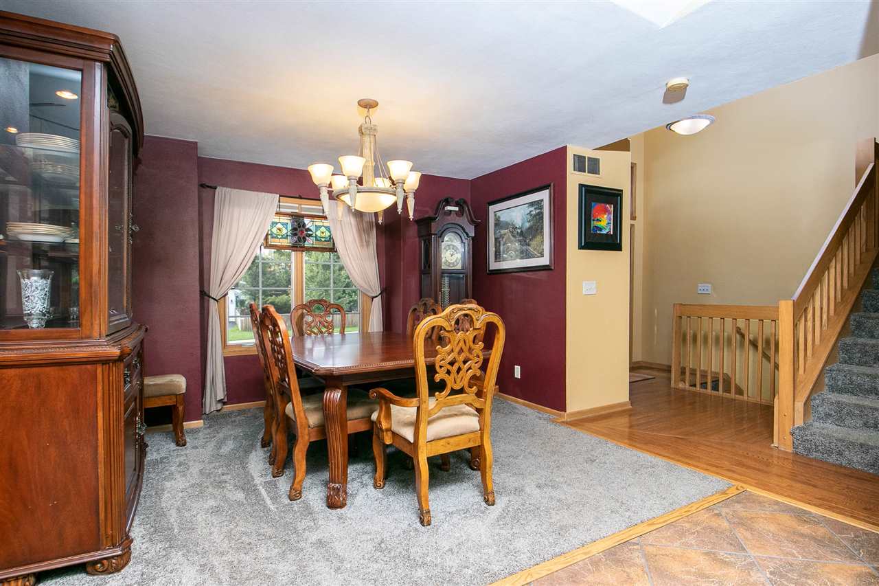 6820 Stone Cottage Road Rockford, IL 61114 - Photo 3 of 24 a view of a dining room with furniture and chandelier