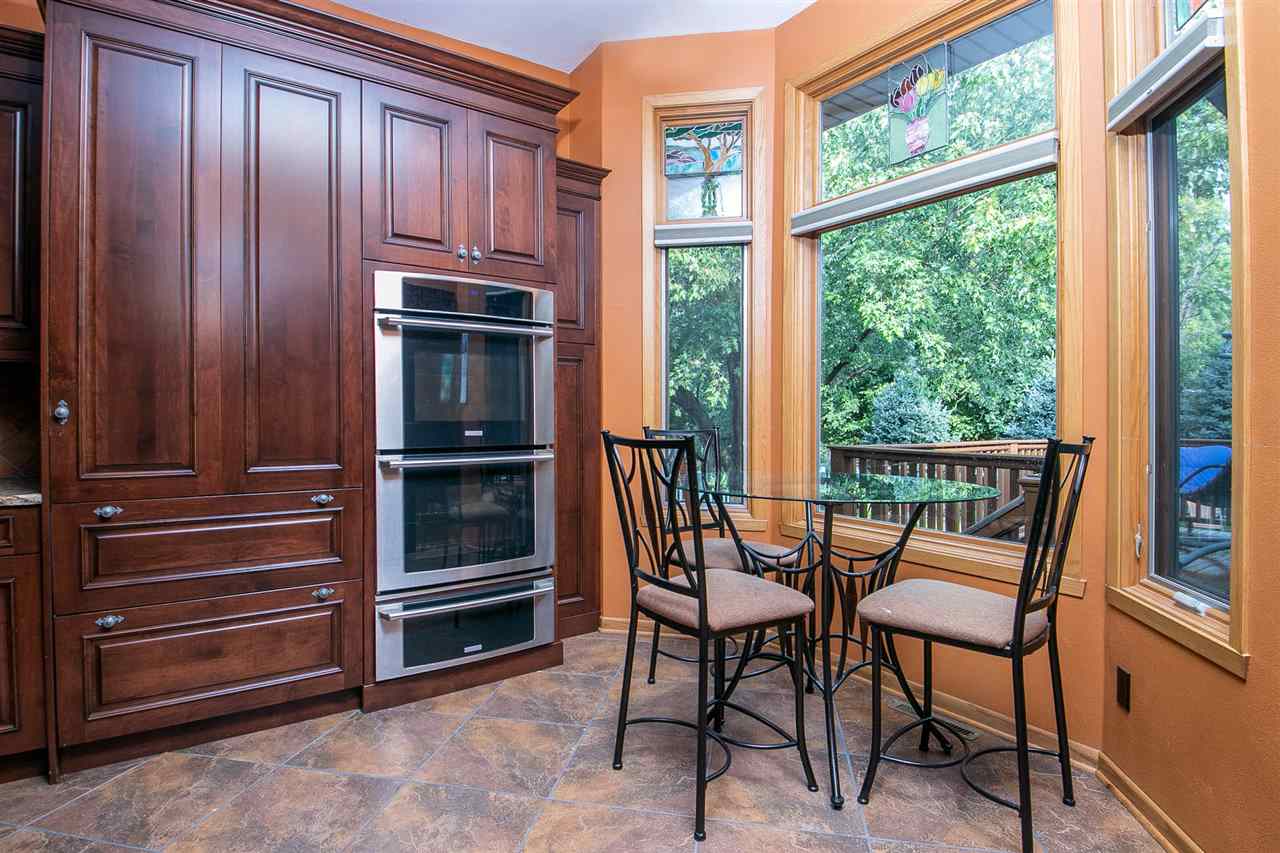 6820 Stone Cottage Road Rockford, IL 61114 - Photo 6 of 24 a balcony with chairs and a stove