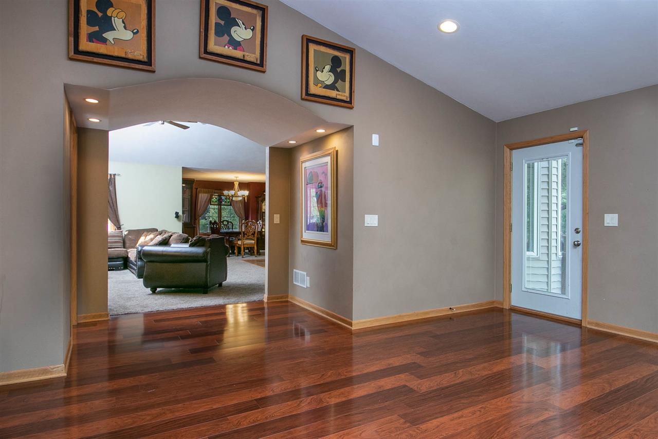 6820 Stone Cottage Road Rockford, IL 61114 - Photo 9 of 24 a living room with furniture and a wooden floor