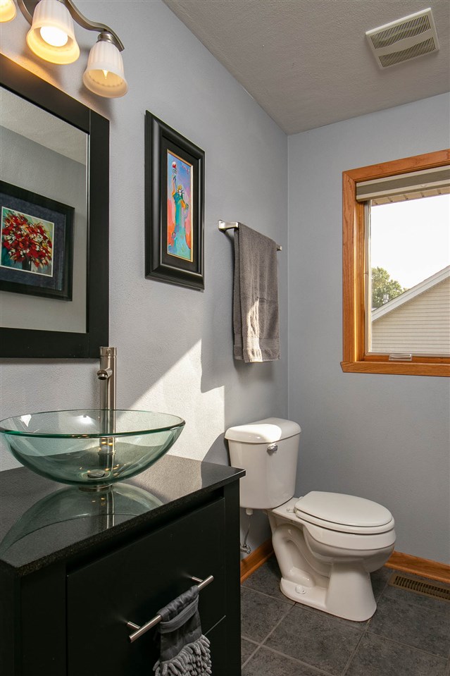 6820 Stone Cottage Road Rockford, IL 61114 - Photo 10 of 24 a white toilet sitting next to a bathroom sink