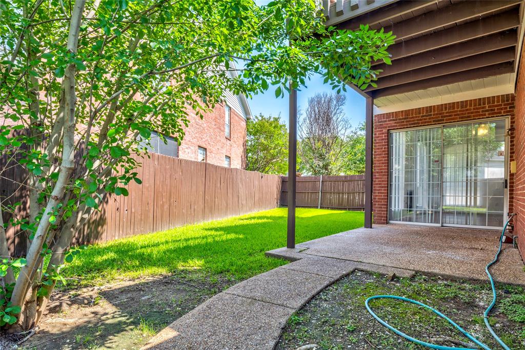 559 Raintree Circle Coppell, TX 75019 - Photo 40 of 40 Private backyard featuring a concrete patio, lush green lawn, and full privacy fencing