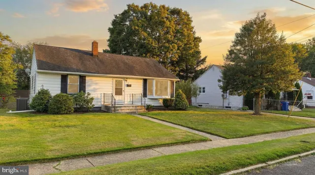a view of a house with a yard patio and fire pit