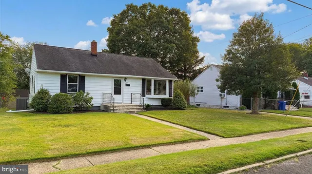 a view of a house with a swimming pool and a yard