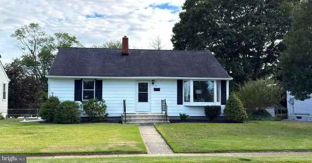 a front view of a house with a garden and plants