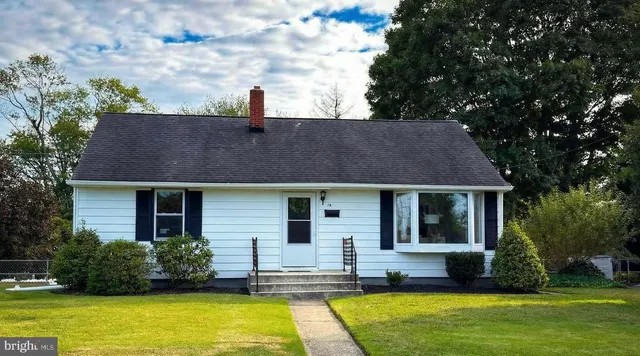 a front view of house with yard and swimming pool