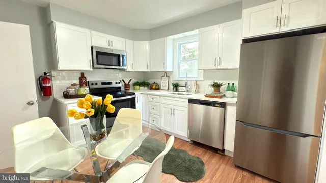 a kitchen with stainless steel appliances a refrigerator sink and cabinets