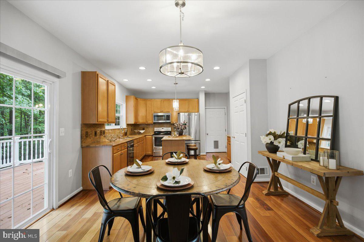 2424 Springbrook Court Huntingtown, MD 20639 - Photo 27 of 103 a view of a dining room with furniture window and wooden floor
