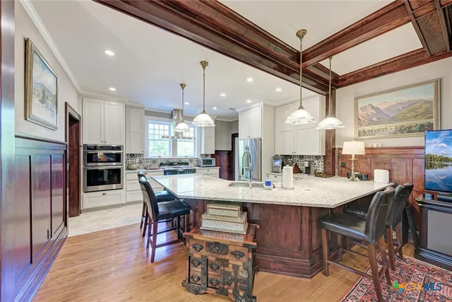 a large kitchen with a table and chairs