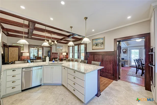 a kitchen with sink and white cabinets