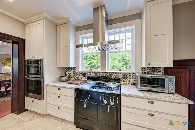 a kitchen with stainless steel appliances a stove sink and microwave