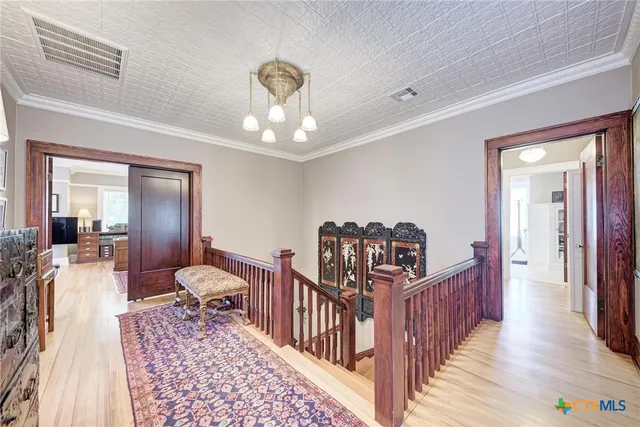 a view of a hallway view with wooden floor and staircase