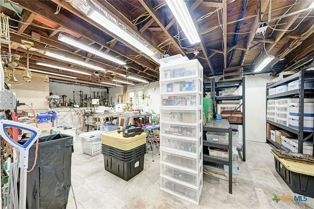 a room with lot of furniture and a kitchen view