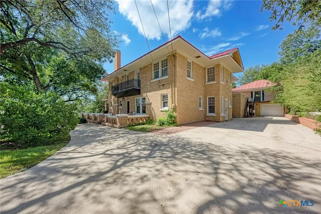 a view of a white house with a yard