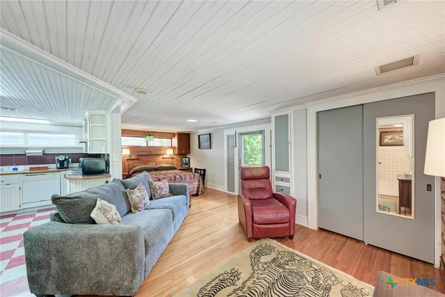 a living room with furniture or couch and a wooden floor