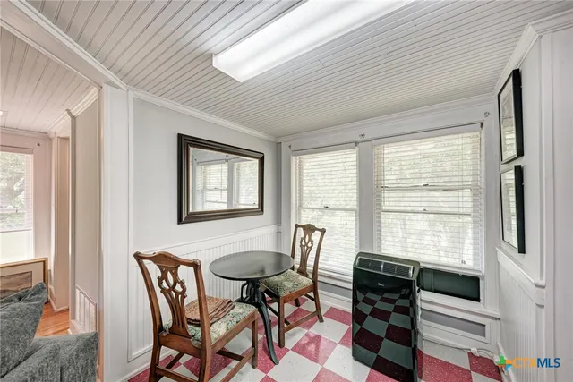 a view of a dining room with furniture and a window