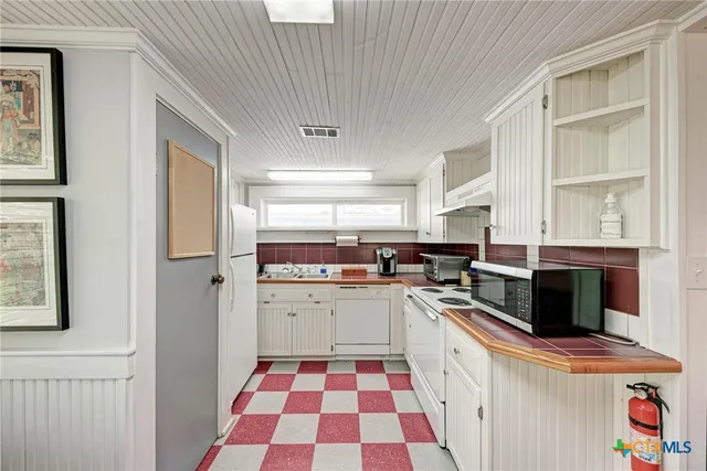 a kitchen with stainless steel appliances a stove a sink and a refrigerator