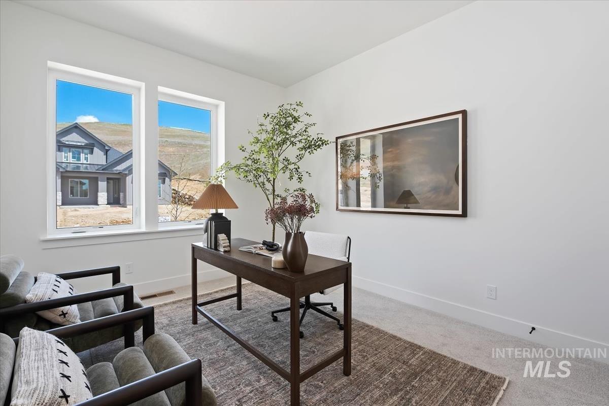 7615 Brown Way Eagle, ID 83714 - Photo 34 of 43 Room featuring two large windows, white walls, and light-toned carpet flooring