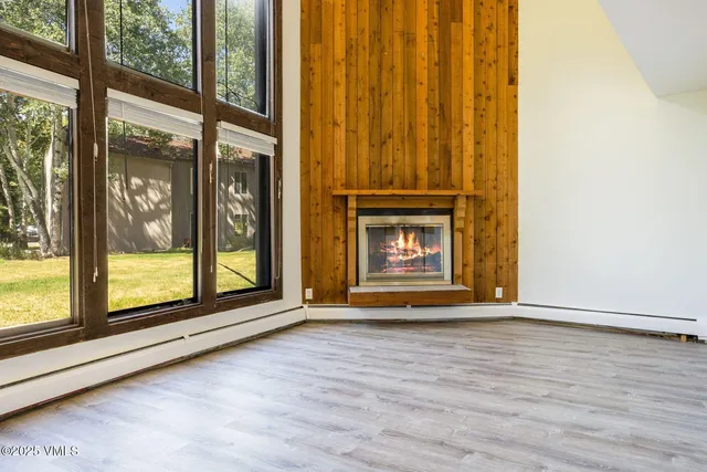 a living room with furniture a fireplace and a window
