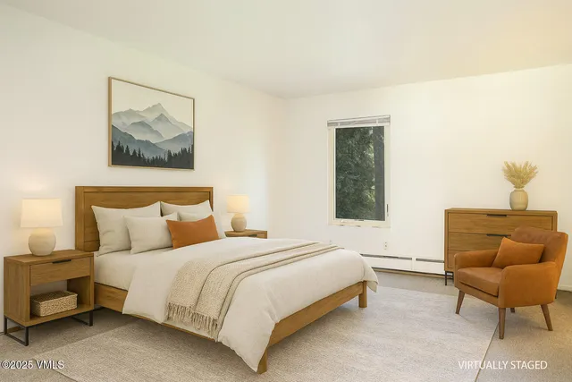 a bedroom with a bed and a chair