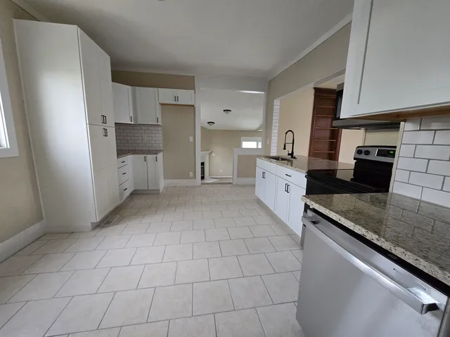 a large kitchen with a stove and a sink