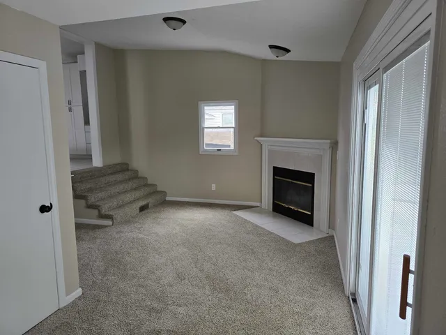 a view of empty room with a fireplace
