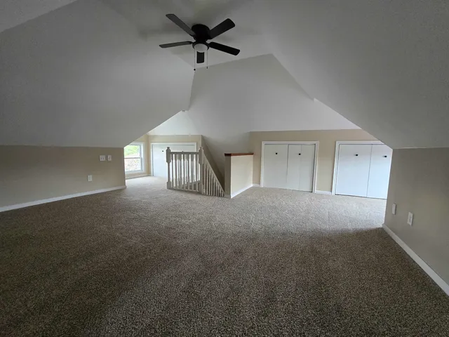 a view of empty room with ceiling fan
