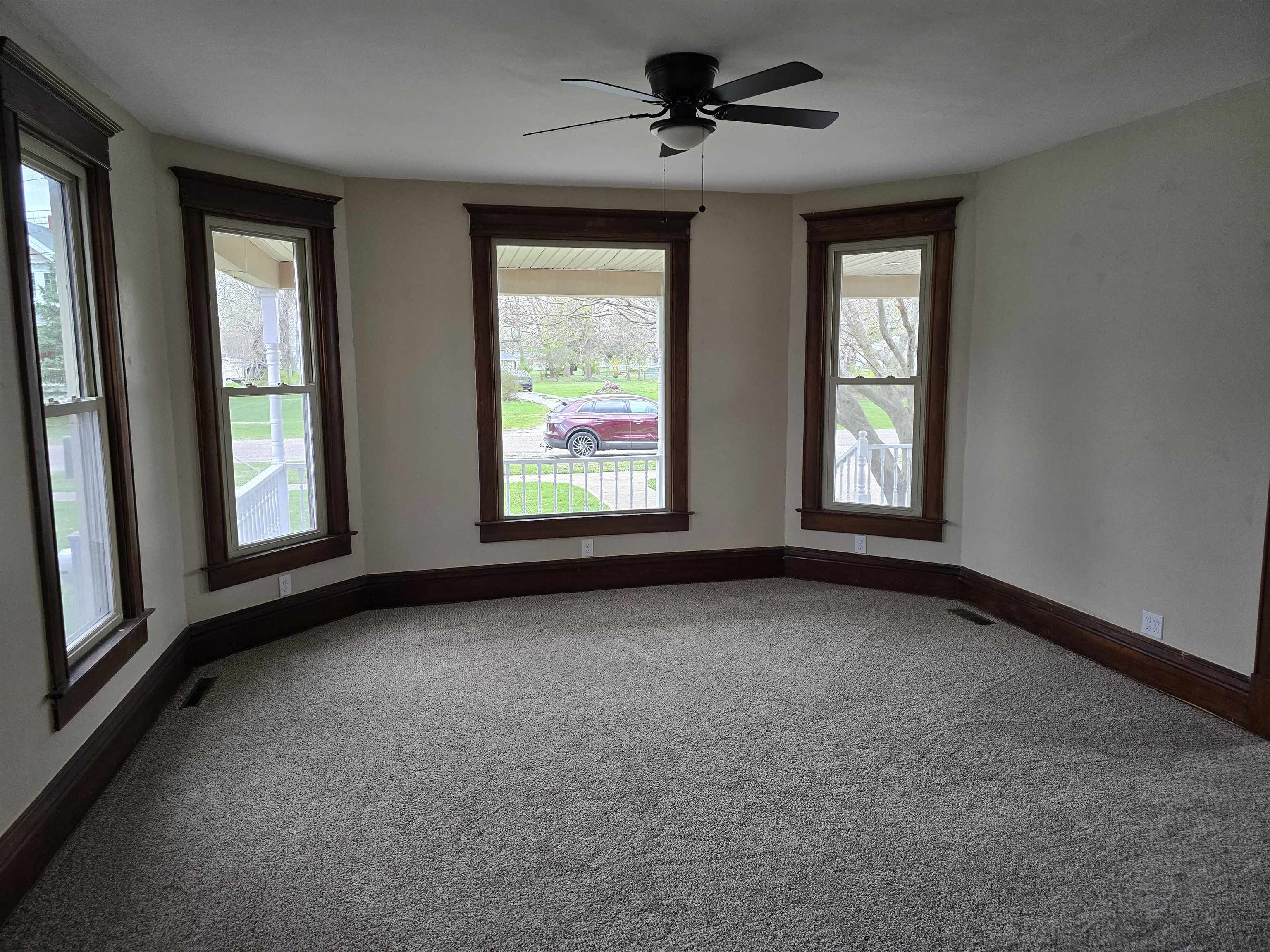 245 Cherry Street Carthage, IL 62321 - Photo 6 of 29 a view of a big room with windows and chandelier fan