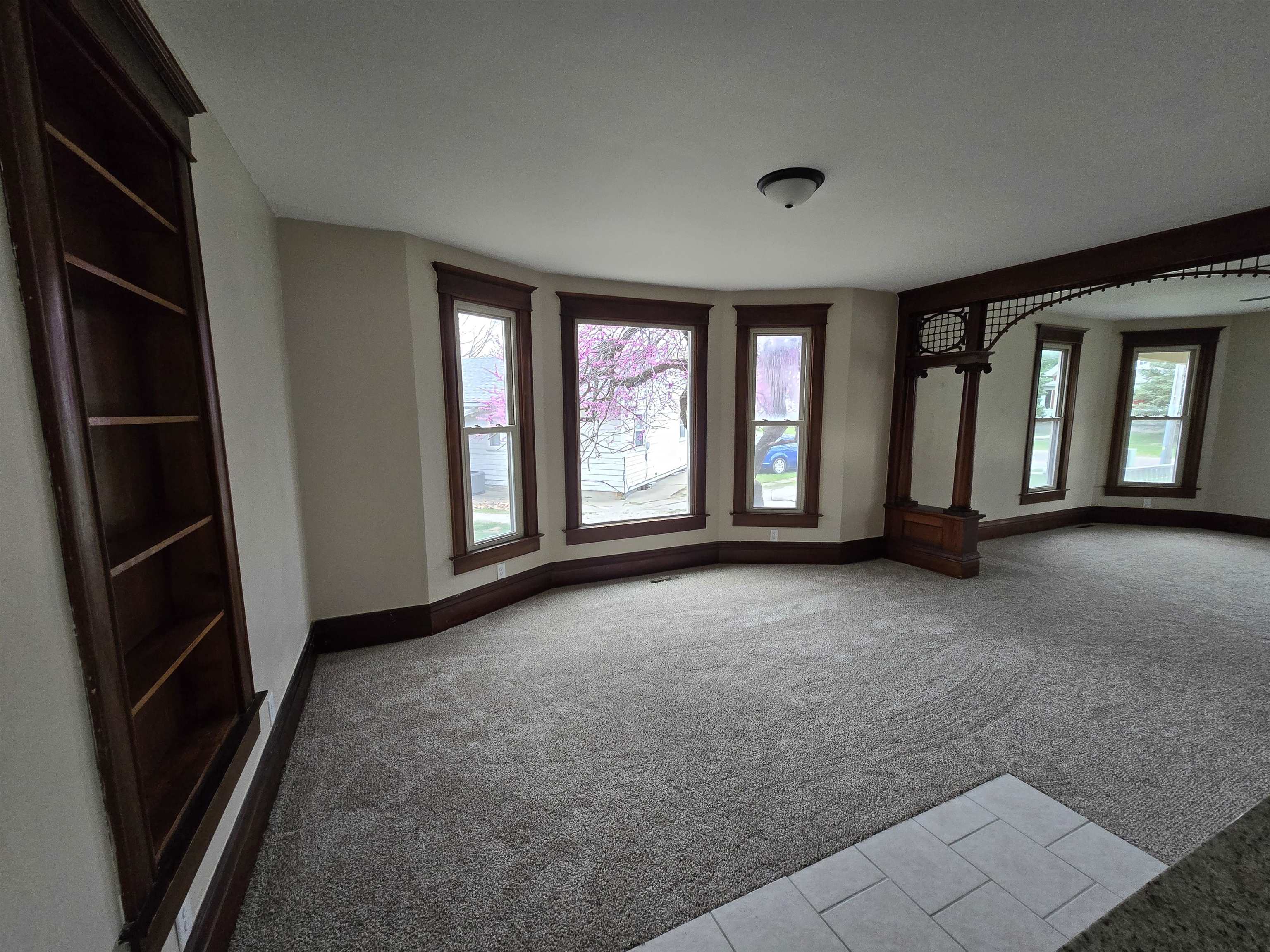 245 Cherry Street Carthage, IL 62321 - Photo 9 of 29 a view of an empty room with a fireplace and a window