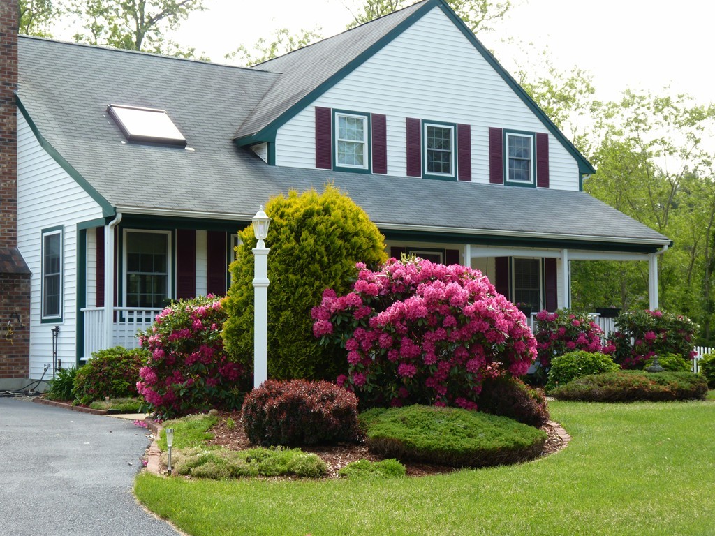 5 Bog Iron Road Wareham, MA 02576 - Photo 2 of 21 a front view of a house with a yard and garage