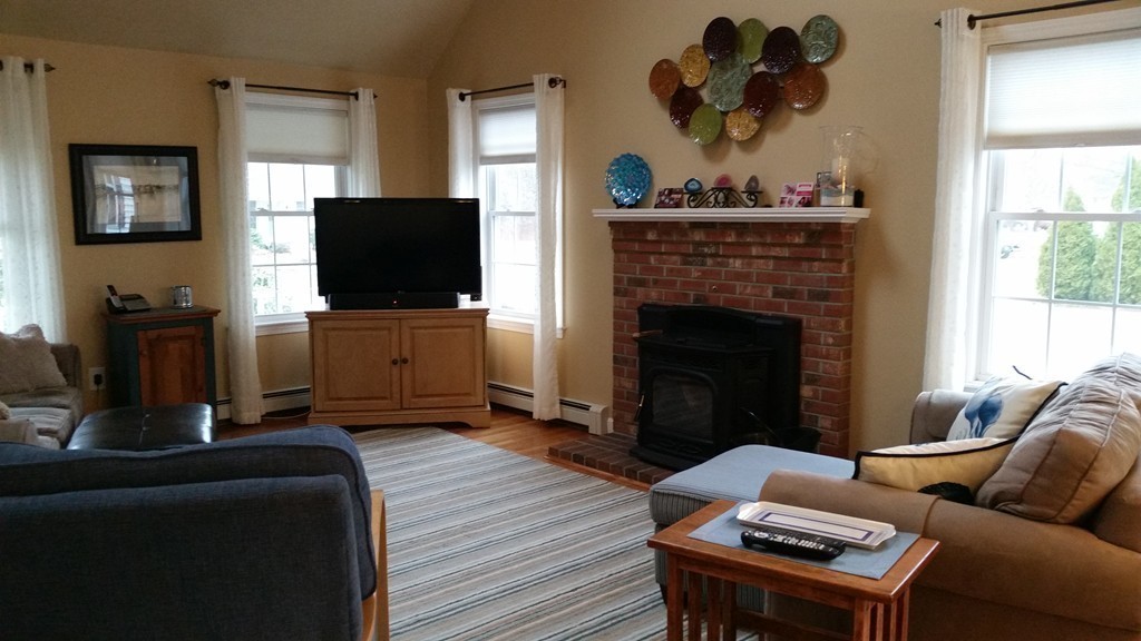5 Bog Iron Road Wareham, MA 02576 - Photo 10 of 21 a living room with furniture a flat screen tv and a fireplace