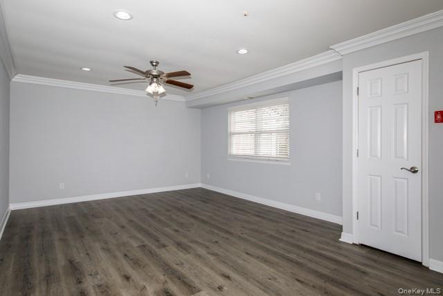 356 Lake Pointe Drive, Unit 356 Middle Island, NY 11953 - Photo 2 of 7 wooden floor in an empty room with a window