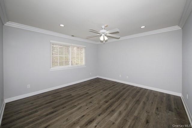 356 Lake Pointe Drive, Unit 356 Middle Island, NY 11953 - Photo 4 of 7 an empty room with wooden floor and windows