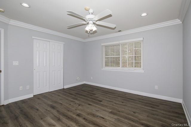 356 Lake Pointe Drive, Unit 356 Middle Island, NY 11953 - Photo 5 of 7 a view of an empty room with wooden floor and a window