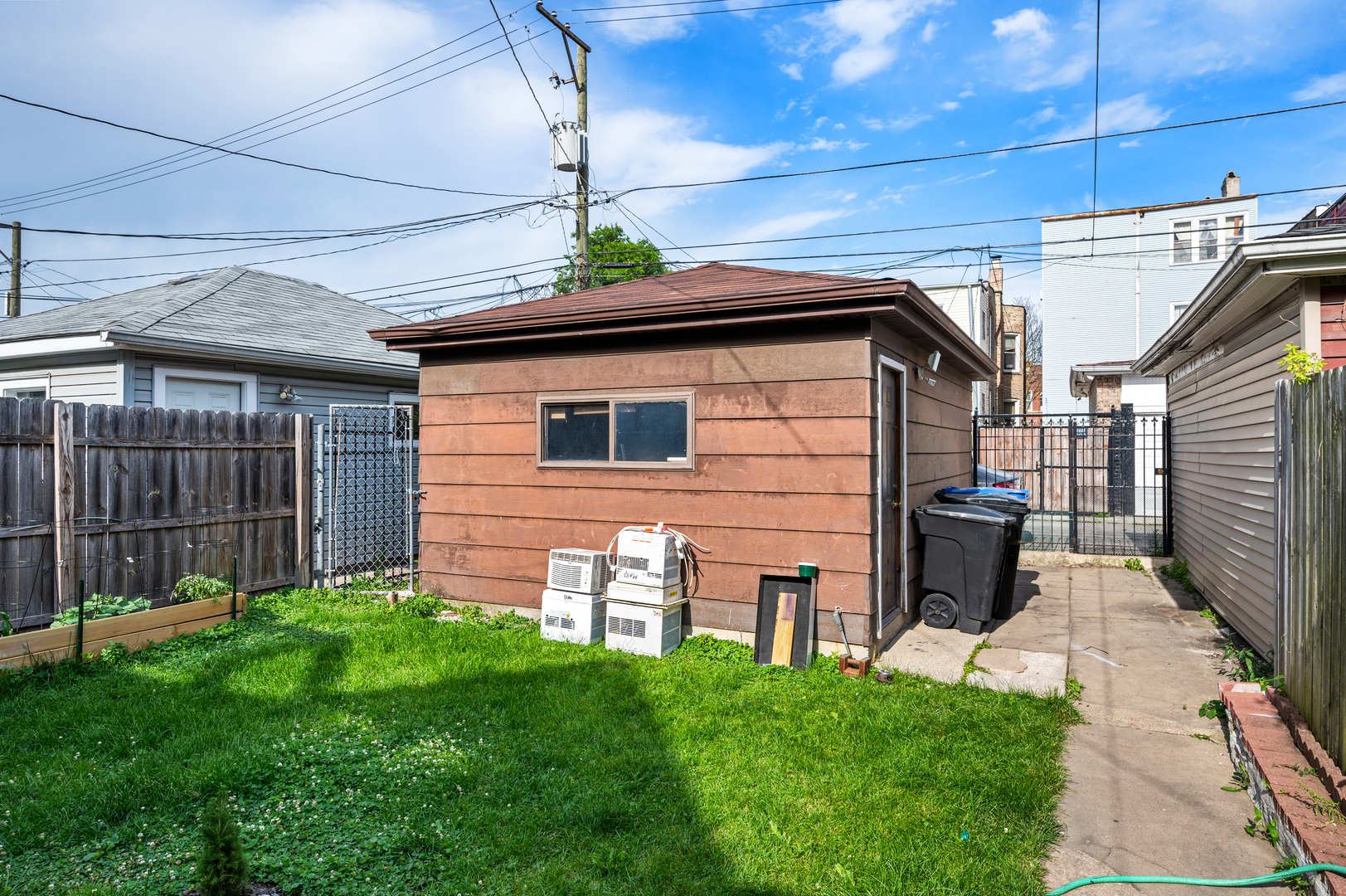 2109 North Karlov Avenue Chicago, IL 60639 - Photo 21 of 22 a view of a backyard with plants and wooden fence