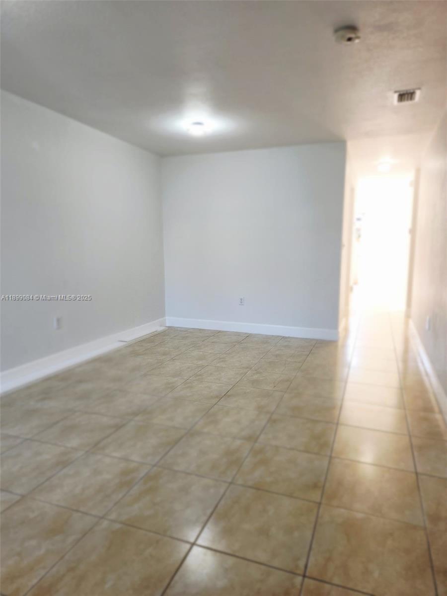 18861 Northwest 86th Court, Unit 3903 Hialeah, FL 33015 - Photo 3 of 14 a view of an empty room