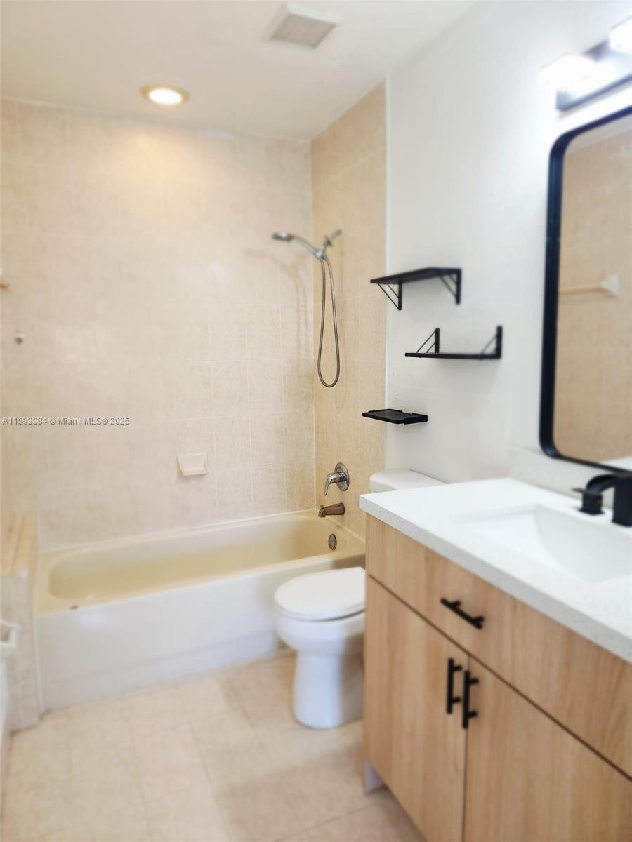 18861 Northwest 86th Court, Unit 3903 Hialeah, FL 33015 - Photo 4 of 14 a bathroom with a sink a toilet and shower