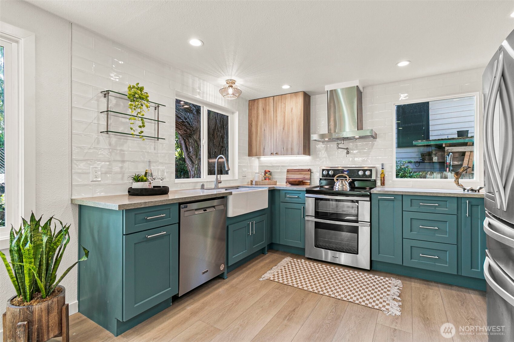 12077 75th Avenue South Seattle, WA 98178 - Photo 13 of 35 a kitchen with a sink cabinets stainless steel appliances and a counter top space